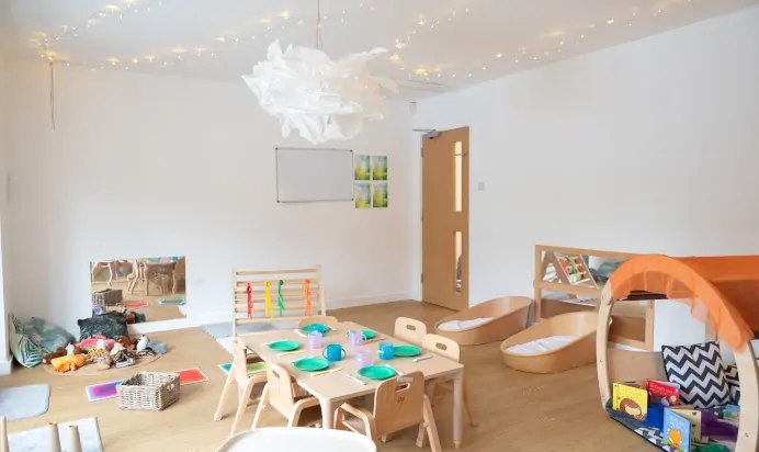 Indoor play area with books toys and wooden table at Kiddi Caru Day Nursery Preschool Coronation Road Downend Bristol