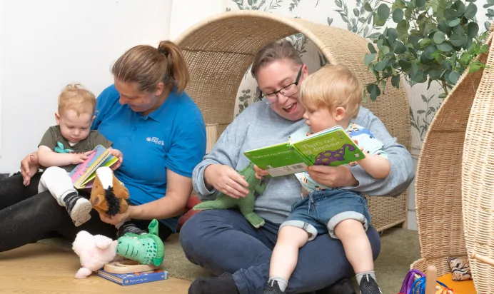 Key workers reading to children at Kiddi Caru Day Nursery Preschool Coronation Road Downend Bristol