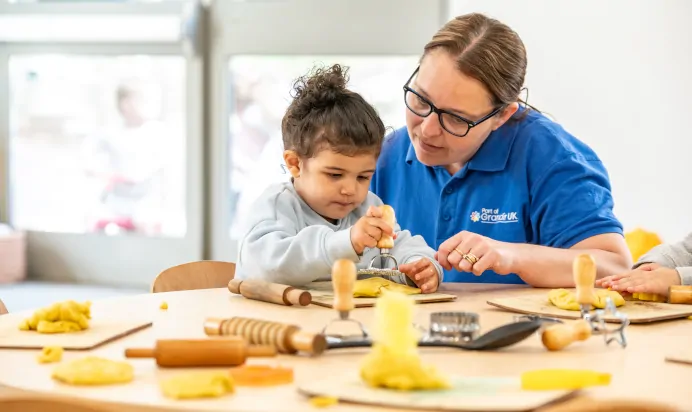 Small child playing with playdough at Kiddi Caru Day Nursery Preschool Soundwell Bristol