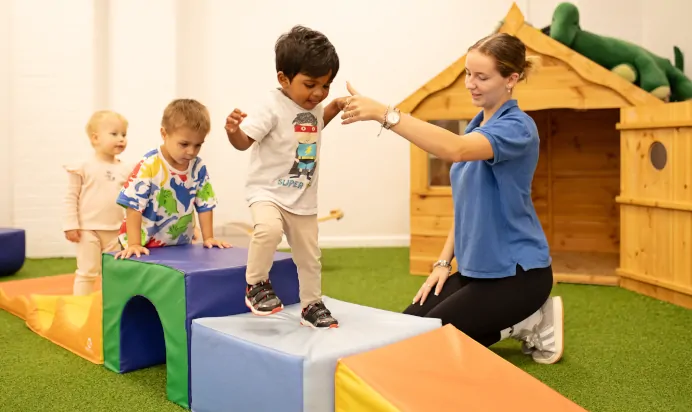 Child climbing on foam blocks at The Elan Day Nursery Haywards Heath