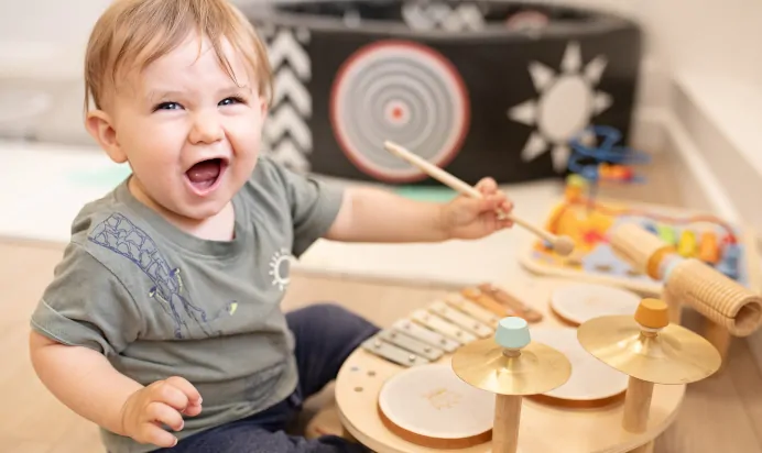 Child playing musical instrument at The Elan Day Nursery Haywards Heath