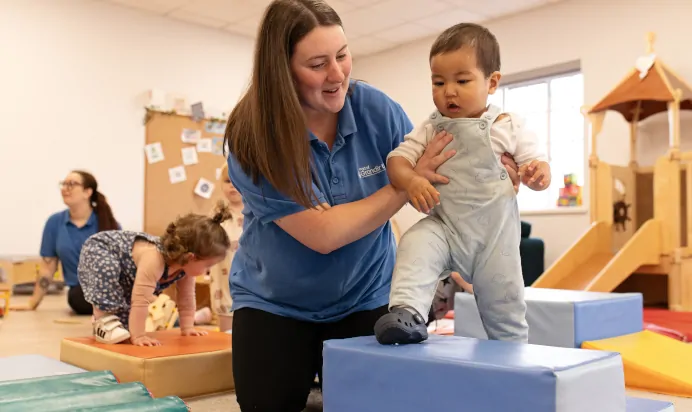 Child stepping on blocks at The Elan Day Nursery Haywards Heath