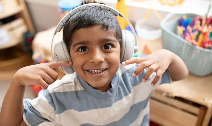 Child wearing headphones at The Elan Preschool Haywards Heath