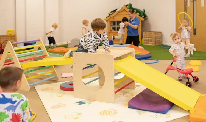 Indoor play space with climbing frame at The Elan Day Nursery Haywards Heath