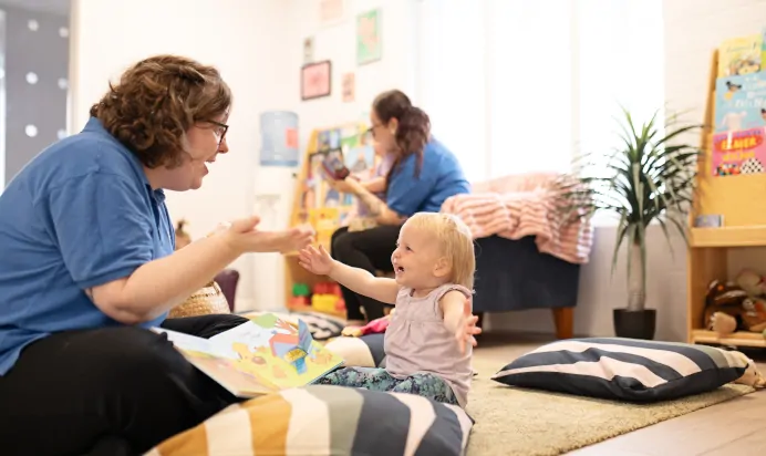 Key worker and child laughing at The Elan Day Nursery Haywards Heath