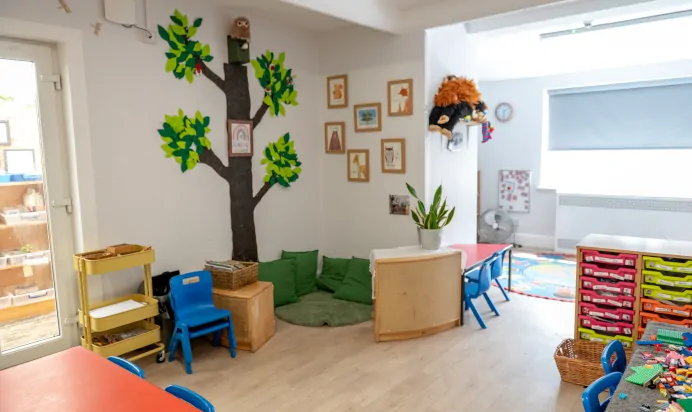 Book corner with tree on the wall at Lake House Day Nursery Preschool Westbury On Trym Bristol