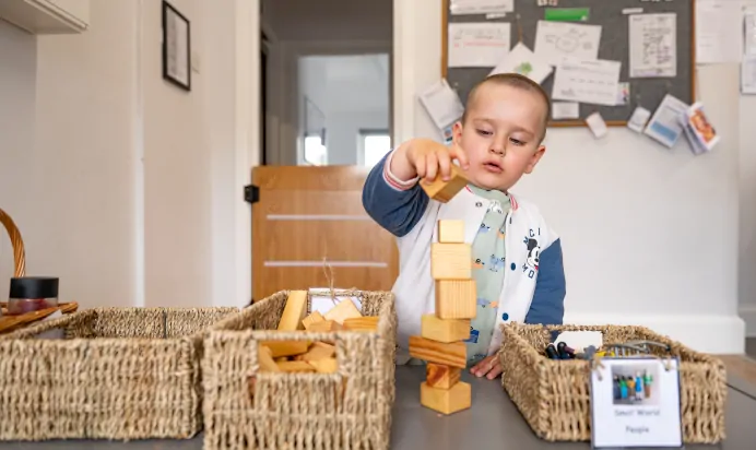 Child building tower of blocks at Lake House Day Nursery Preschool Westbury On Trym Bristol
