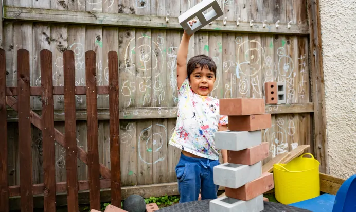 Child playing with foam bricks at Lake House Day Nursery Preschool Westbury On Trym Bristol