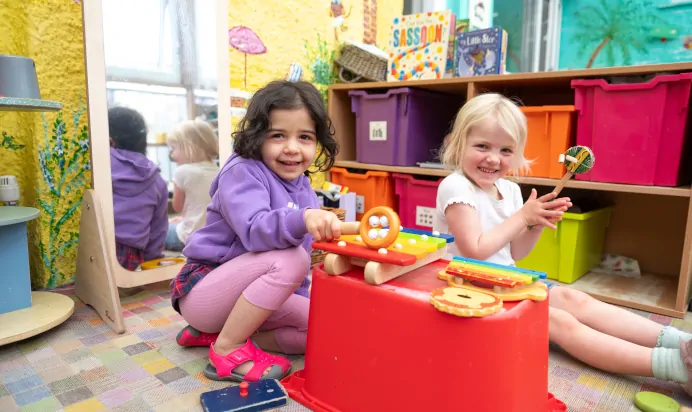 Children playing with musical instruments outside at Lake House Day Nursery Preschool Westbury On Trym Bristol