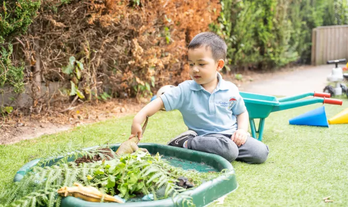 Child in outside space playing at The Puddleduck Day Nursery St Martins Church Ascot
