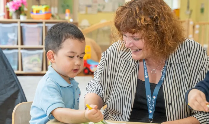 Child painting with keyworker at The Puddleduck Day Nursery St Martins Church Ascot