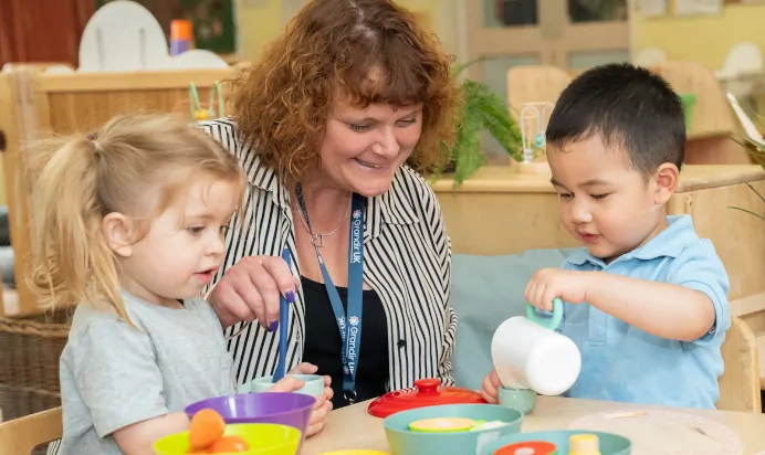 Children playing in kitchen with fake food at The Puddleduck Day Nursery St Martins Church Ascot