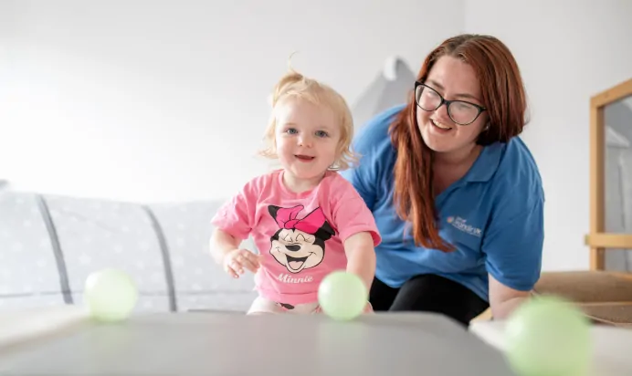 Child laughing with key worker at The College Town Montessori Nursery Preschool Sandhurst