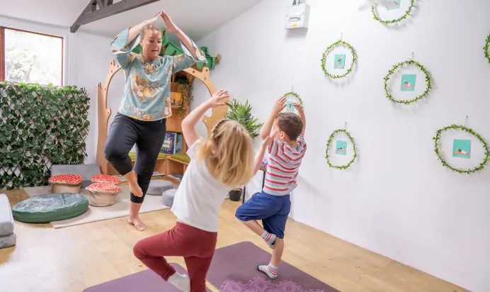 Children doing yoga with key worker at The College Town Montessori Nursery Preschool Sandhurst