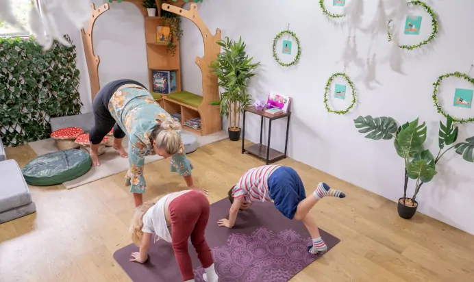 Children stretching with key worker at The College Town Montessori Nursery Preschool Sandhurst