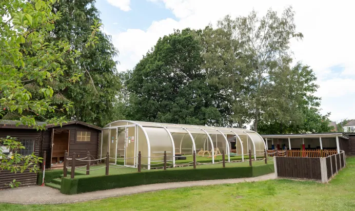 Outdoor space with green house at The College Town Montessori Nursery Preschool Sandhurst
