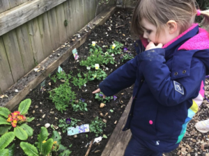 children planting flowers for earth day