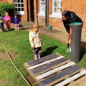Child practising safety in outdoor play in the garden