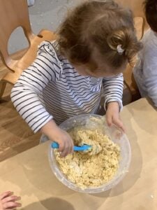 Children at Kiddi Caru Day & Preschool in Wellingborough doing healthy baking activity. 