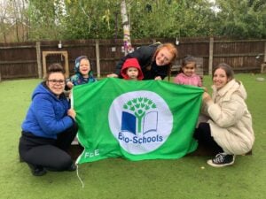 The children and staff at Kiddi Caru celebrating being an Eco-Schools nursery in Wellingborough. 