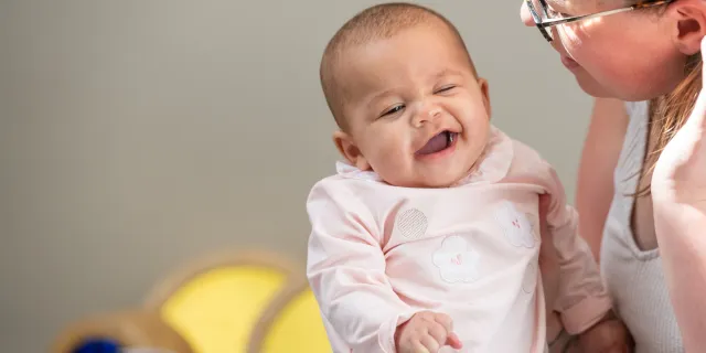 Baby pulling a cheeky face at the nursery