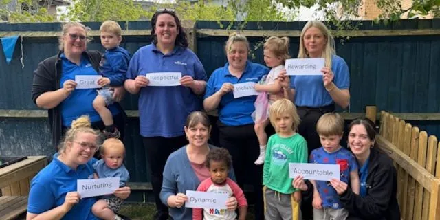 Team leaders and children pose for photo at Kiddi Caru Day Nursery